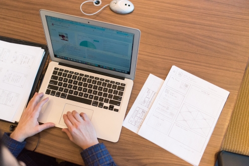 Person s hands on top of macbook air