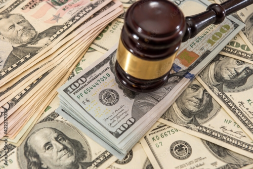 Wooden judge gavel and us money dollar bills